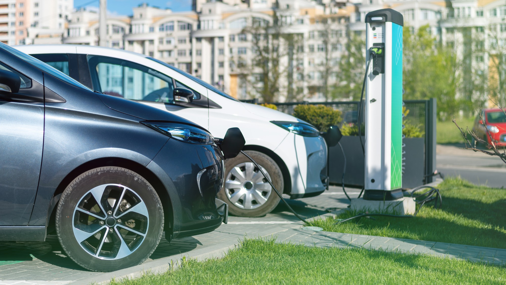 Top EV cars in India 2025 — Two electric vehicles charging at a station, representing the best 5 EV options to consider in India.